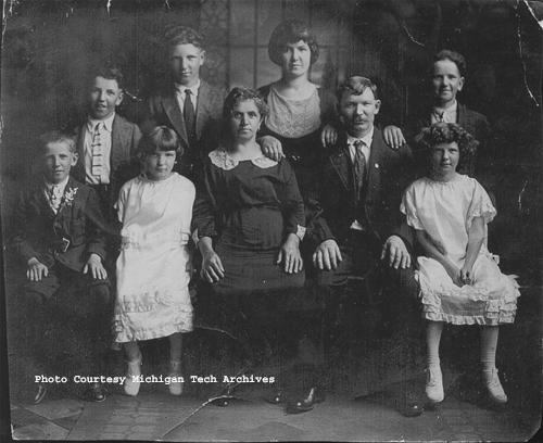 The Putrich family after moving to St. David, Illinois. Standing, left to right: Fabian, Frank, Mary (Mrs. Joseph Tadejevic), and Paul. Sitting, left to right, John, Sylvia (Mrs. John Tomlianovich), Antonia (Grubisich), Joseph, Josephine (Mrs. William Aubrecht). [The family's boardinghouse in Seeberville, near Painesdale, was the site of an August 1913 shooting. Strike deputies fired shots into the building, killing Steve Putrich and Louis Tijan.]