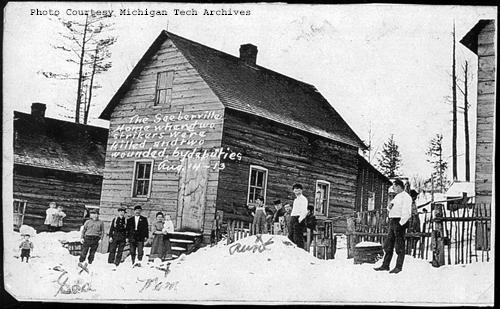 View of the home in Seeberville, MI where Steve Putrich and Louis Tijan were killed. The Putrich boardinghouse at #17 Second Street in Seeberville was rented from the Copper Range . The man labeled "Dad" is Joseph Putrich, the woman labeled "Mom," is Antonia Putrich, the woman labeled "Aunt," is Josephine (Grubesich) Tijan, and the others are likely the Putriches' children and boarders/relatives. According to Kim Hoagland in her article "The Boardinghouse Murders: Housing and American Ideals in Michigan's Copper Country in 1913," Croatian immigrants Joseph and Antonia Putrich rented the house from the Copper Range Mining Company. At the time these photos were taken, they had four children under the age of four, one hired girl, Josephine Grubesich (Antonia's sister), and ten male boarders, including Joseph's brother Steve Putrich, who died in the shooting, and his nephews Albert and Louis Tijan (Louis also died in the shooting, and Albert later married Antonia's sister Josephine). The other boarders included John Kalan and his eighteen-year-old son Slave, John Stimac, and two others. This is a rare view of a working-class, boarding house interior. - Jeremiah Mason, with thanks to Kim.